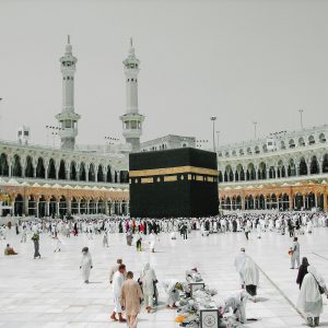 a group of people standing around a large building